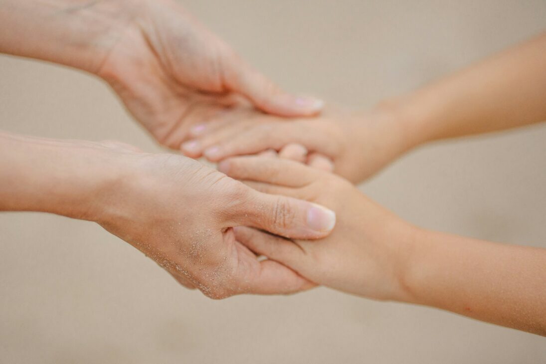 Two hands gently holding each other