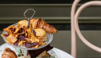 a three tiered tray of pastries on a table