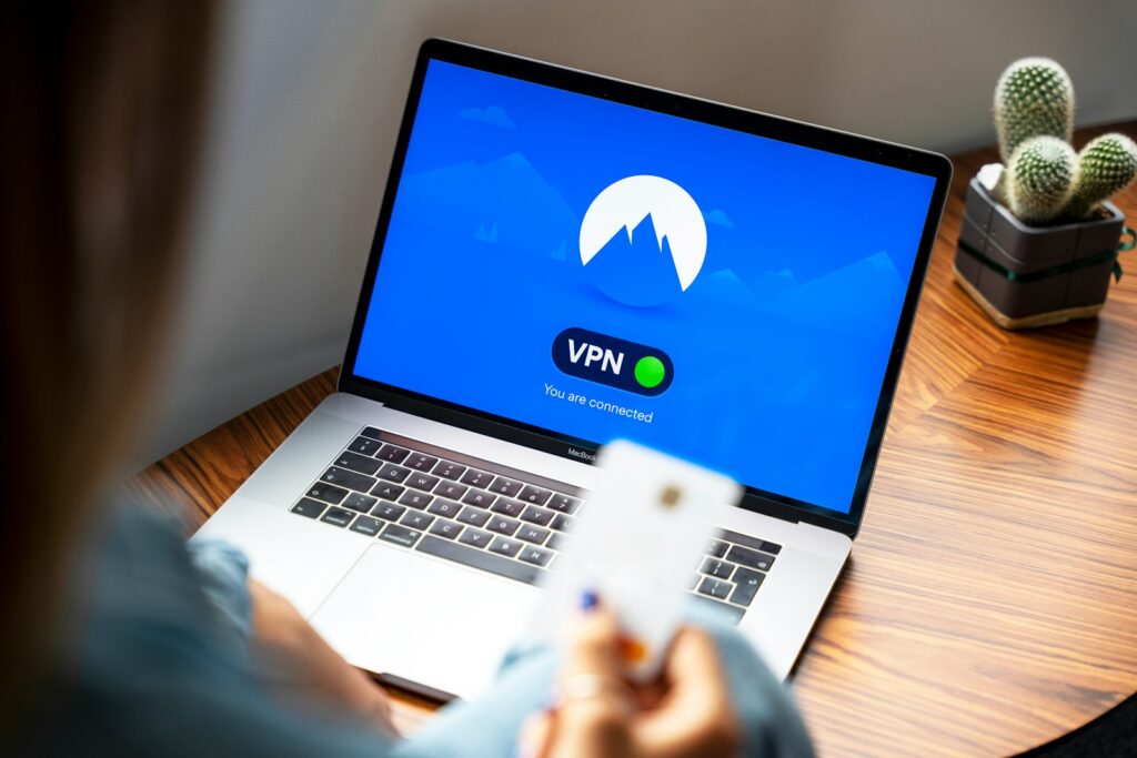 macbook pro on brown wooden table VPN - The Ultimate Guide to VPNs for Streaming