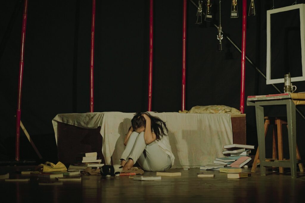 a woman sitting on the floor in front of a couch