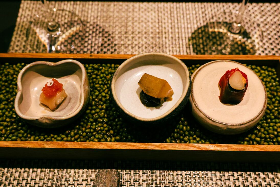 Three plates of food on a tray on a table