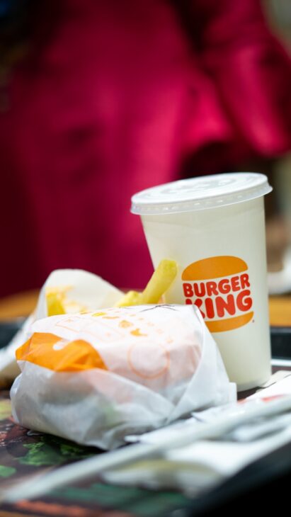 a burger king sandwich and a cup of coffee
