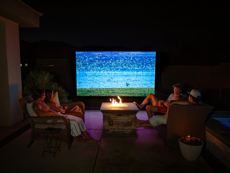 A group of people sitting around a fire pit