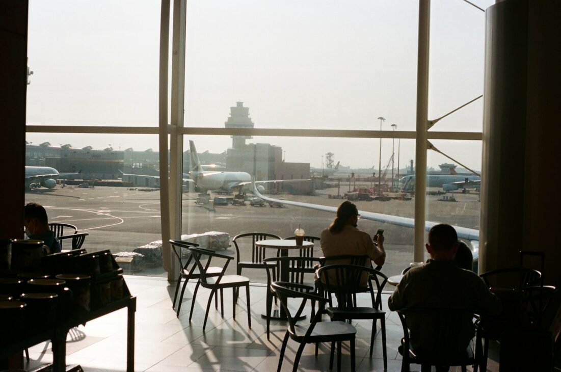 a couple of people sitting at a table in front of a window