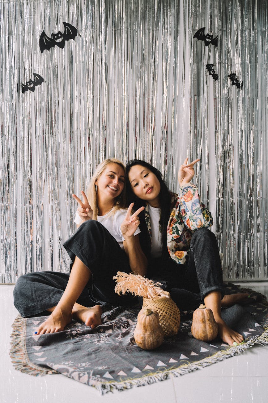 photo of women posing near halloween decorations